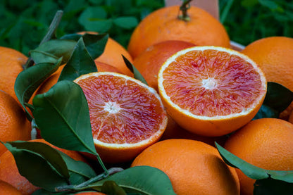 Blood oranges with cut fruit showing red flesh